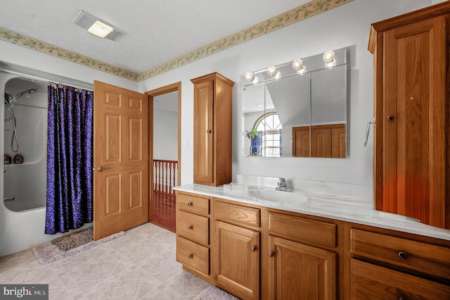 bathroom with a textured ceiling, visible vents, shower / tub combo with curtain, and vanity