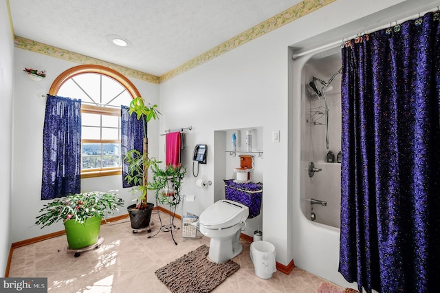 bathroom featuring baseboards, toilet, shower / tub combo with curtain, tile patterned floors, and a textured ceiling