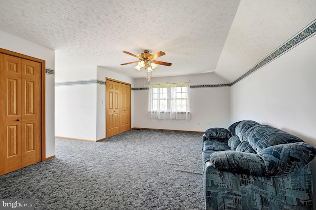 interior space featuring ceiling fan, a textured ceiling, and baseboards