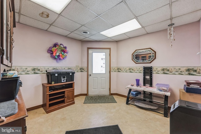 entryway featuring a paneled ceiling, visible vents, and baseboards