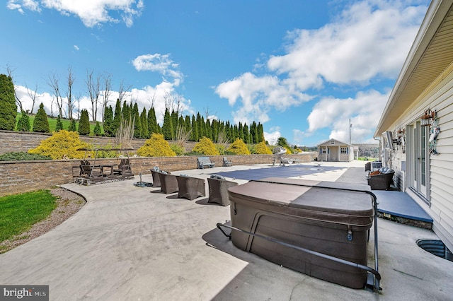 view of patio / terrace featuring a hot tub, central AC unit, and an outdoor structure