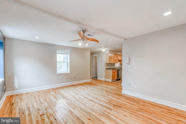 unfurnished living room with ceiling fan and light hardwood / wood-style flooring