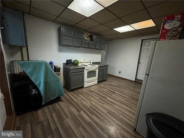 kitchen featuring gray cabinets, white appliances, dark hardwood / wood-style flooring, and a drop ceiling