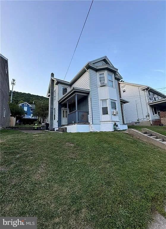 view of side of home with a lawn