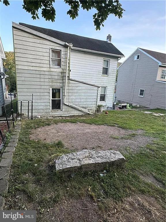 back of property with a yard