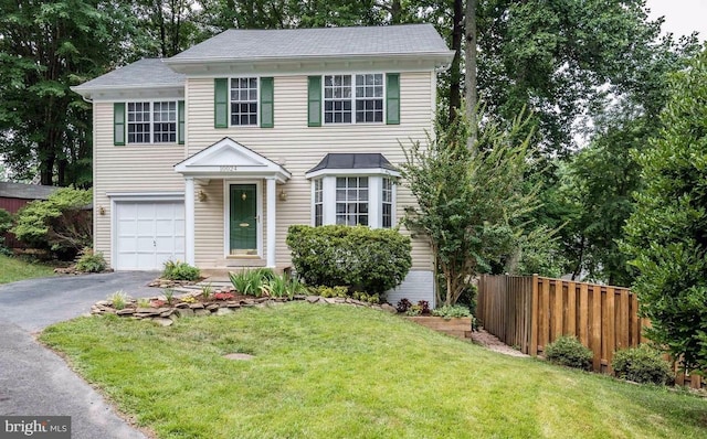 view of front of house featuring a garage and a front lawn