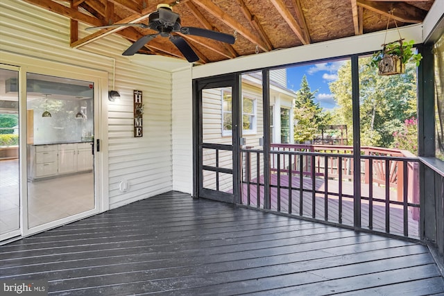 unfurnished sunroom featuring ceiling fan