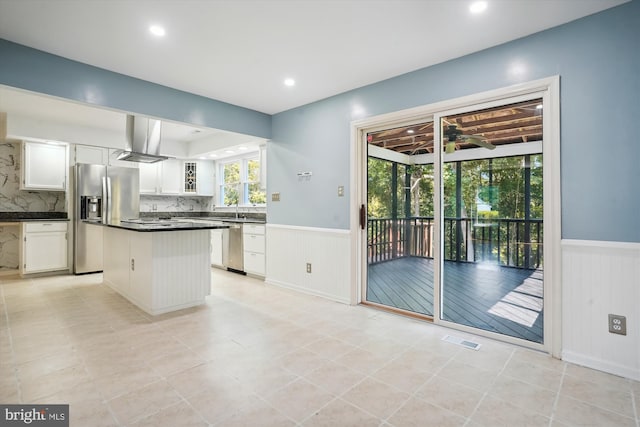 kitchen with visible vents, dark countertops, white cabinetry, appliances with stainless steel finishes, and wainscoting