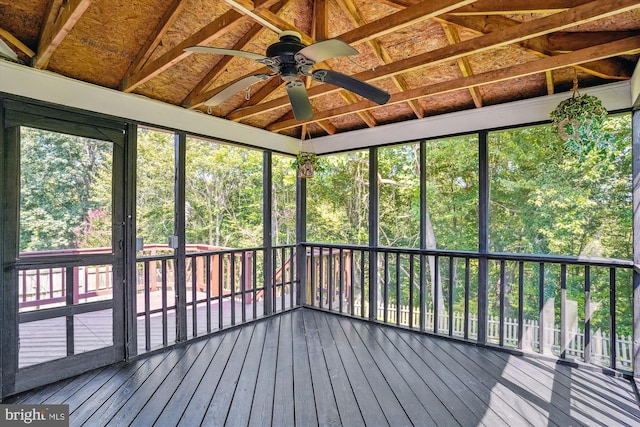 unfurnished sunroom featuring ceiling fan and vaulted ceiling