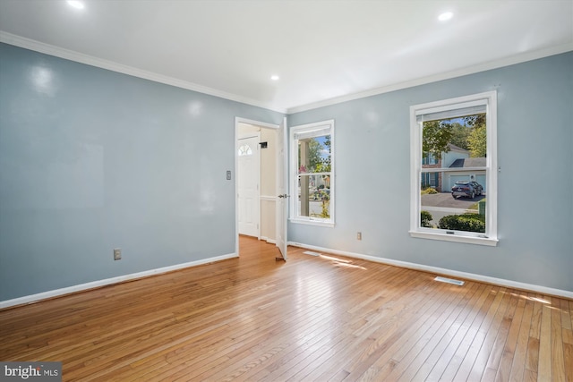 unfurnished room featuring visible vents, crown molding, baseboards, and hardwood / wood-style floors