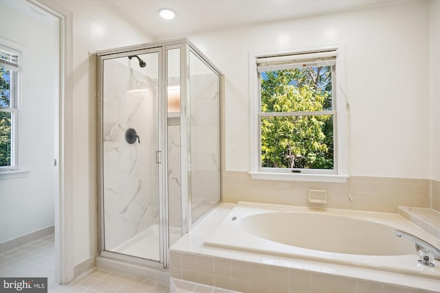 bathroom with recessed lighting, a marble finish shower, and a bath