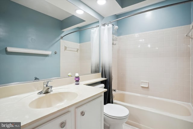 bathroom featuring shower / bathtub combination with curtain, toilet, and vanity