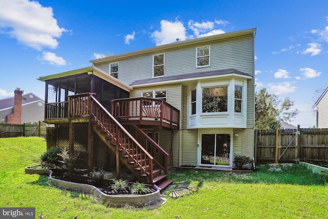 back of house featuring a fenced backyard, stairway, a yard, and a sunroom