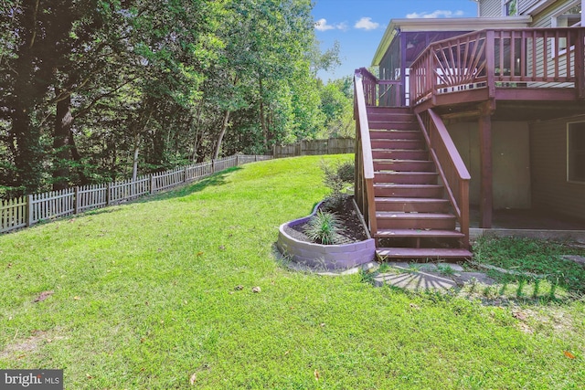 view of yard with a deck, a fenced backyard, and stairs