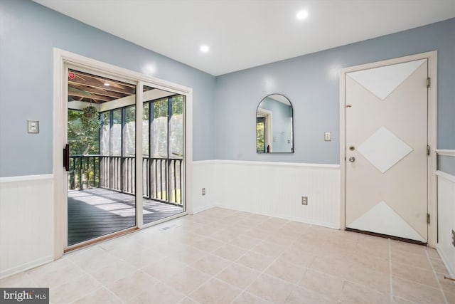 interior space featuring tile patterned floors, a wainscoted wall, recessed lighting, and visible vents