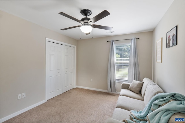 living room with ceiling fan and light colored carpet