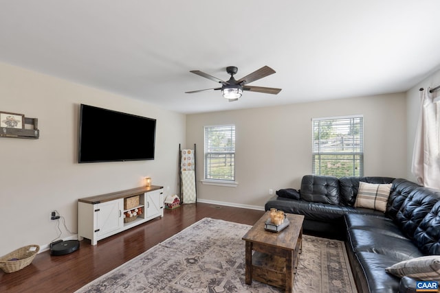 living room with ceiling fan, plenty of natural light, and dark hardwood / wood-style flooring