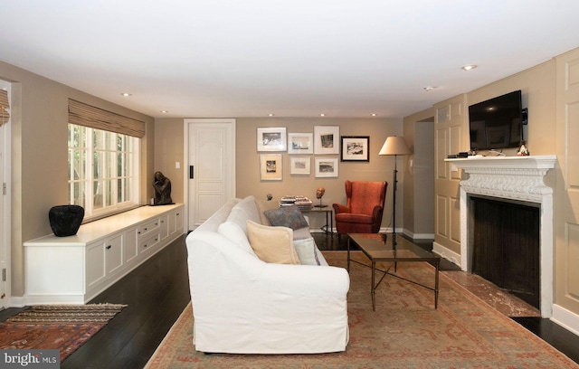 living room with dark wood-style floors, a fireplace, baseboards, and recessed lighting