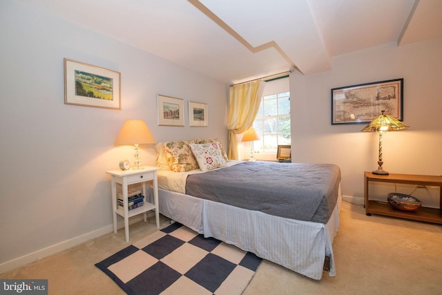 bedroom featuring carpet and baseboards