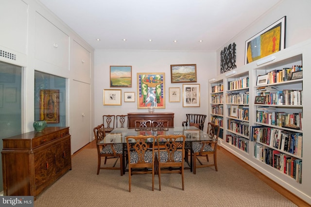 dining area with ornamental molding and recessed lighting