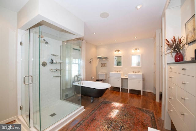 full bath with a freestanding bath, wood finished floors, a shower stall, and vanity