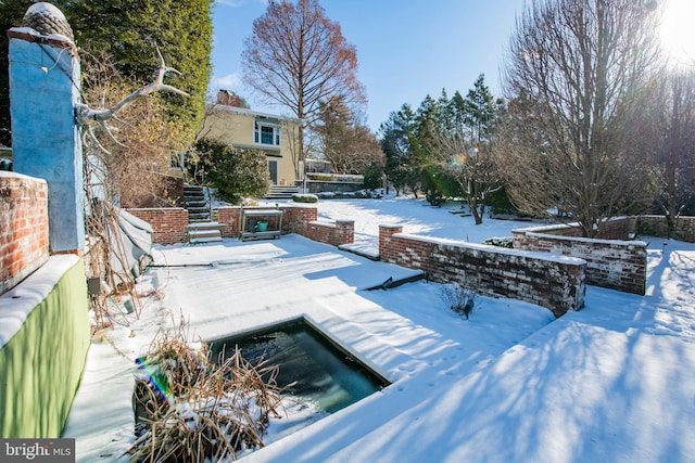 snow covered pool with a patio area