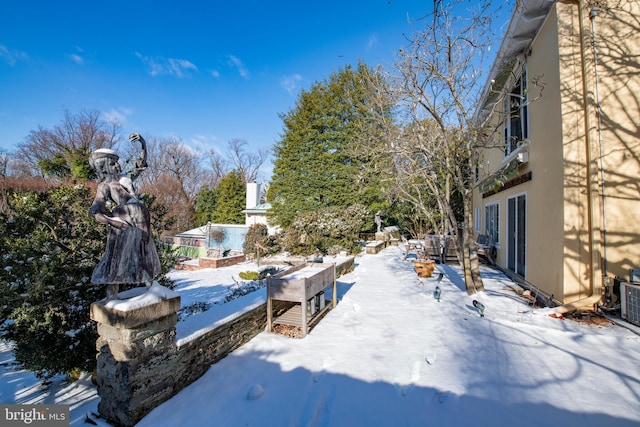 yard covered in snow featuring a balcony