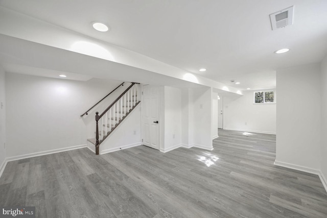 basement with hardwood / wood-style flooring