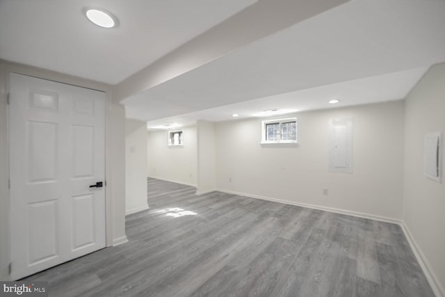 basement featuring electric panel and hardwood / wood-style floors