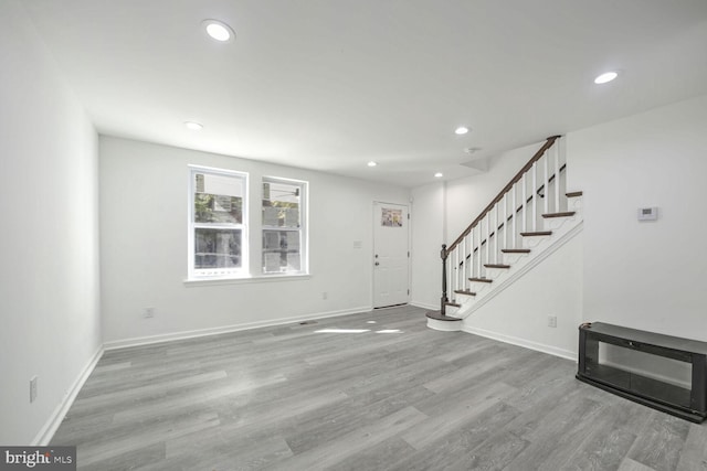 foyer with light hardwood / wood-style floors and heating unit