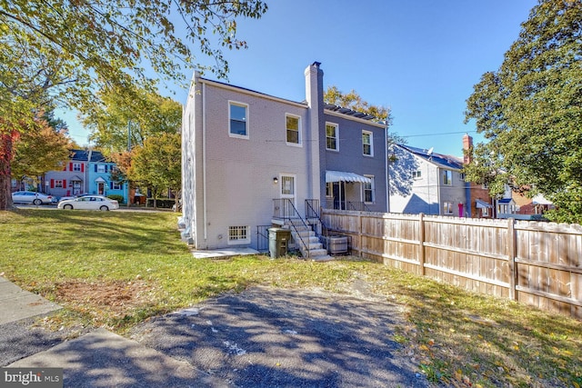 rear view of house with a lawn