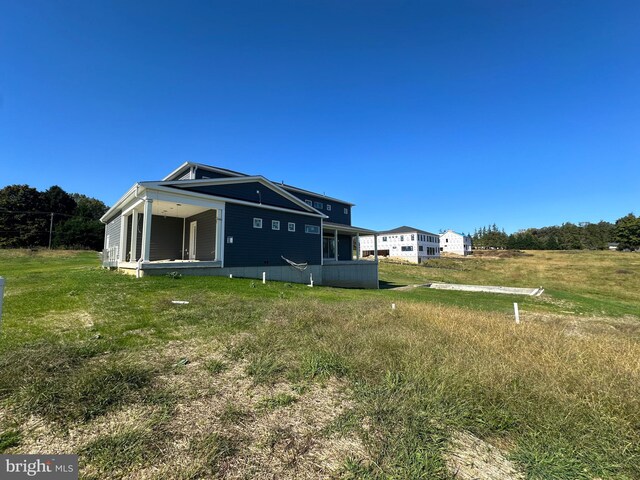 back of house with a yard