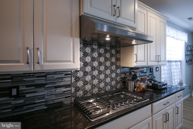 kitchen with stainless steel gas cooktop, white cabinetry, and tasteful backsplash