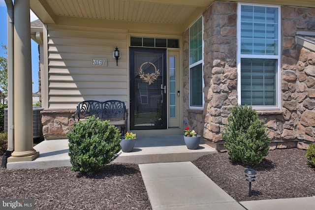 view of exterior entry with covered porch