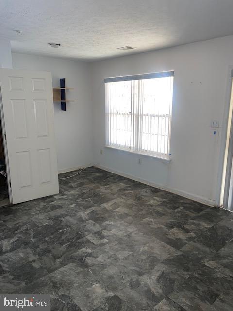 empty room featuring a textured ceiling