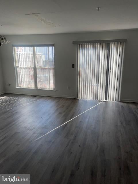 unfurnished room with hardwood / wood-style floors