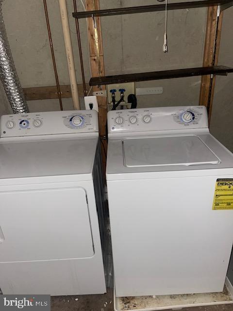 clothes washing area with separate washer and dryer