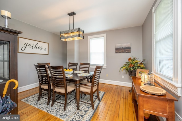 dining room with light wood-style flooring and baseboards