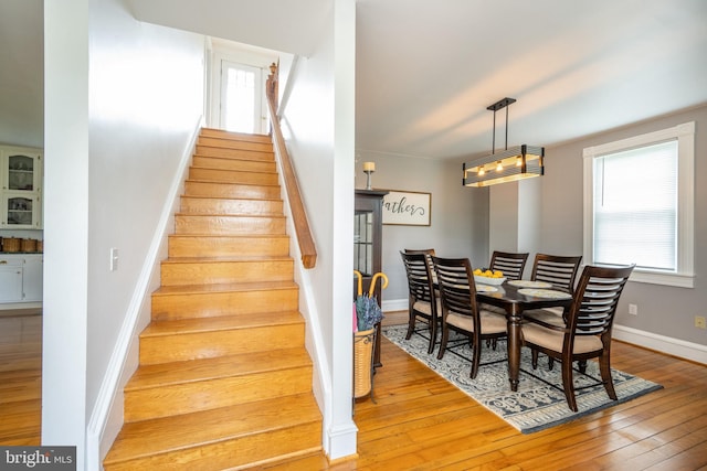 stairway featuring baseboards and wood finished floors