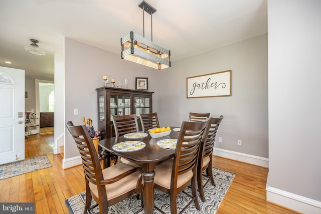 dining room with light wood-style flooring and baseboards