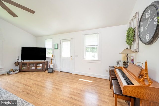 interior space with lofted ceiling, ceiling fan, and light wood-type flooring