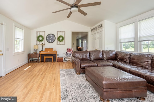 living room featuring lofted ceiling, light hardwood / wood-style flooring, and ceiling fan