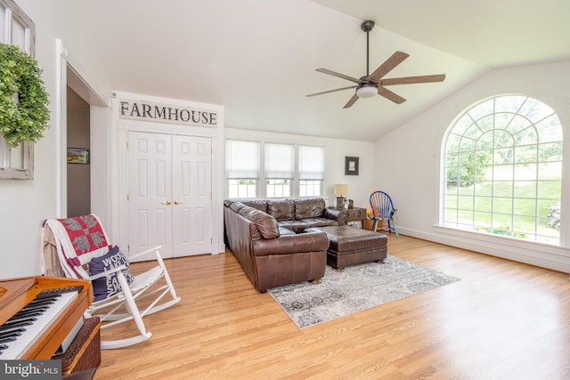 living room featuring lofted ceiling, ceiling fan, and light hardwood / wood-style floors