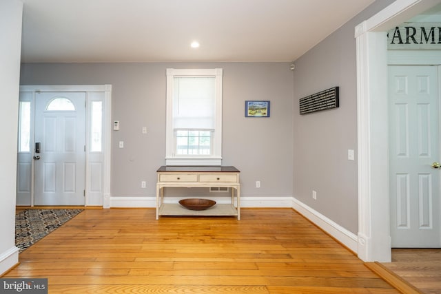 foyer entrance with light wood-style floors, recessed lighting, and baseboards