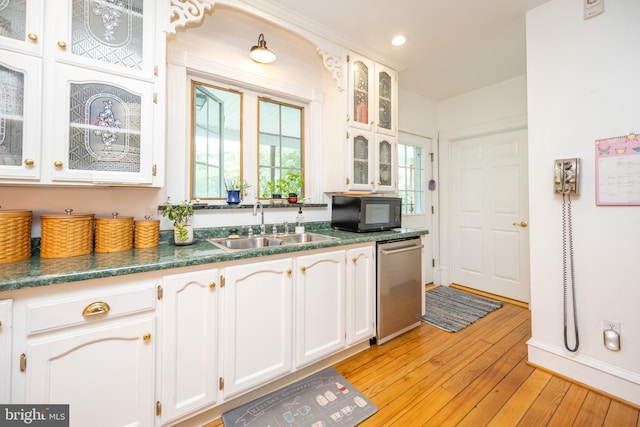 kitchen with white cabinets, dishwasher, light hardwood / wood-style floors, and sink