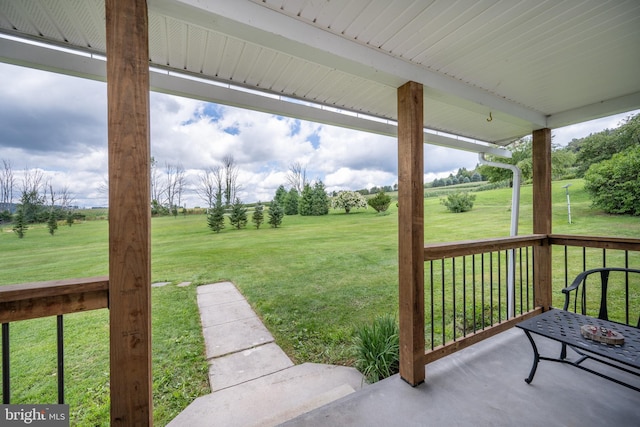 view of yard featuring covered porch and a rural view