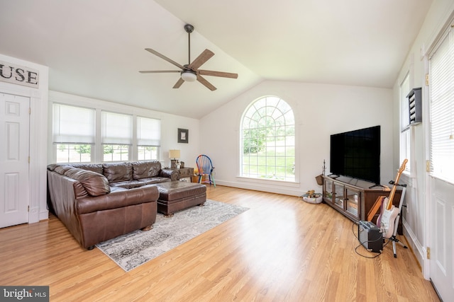 living area featuring vaulted ceiling, wood finished floors, and a ceiling fan