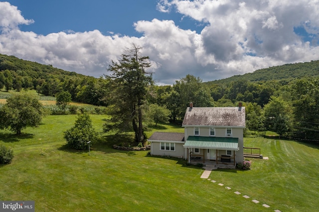 exterior space featuring a yard and a view of trees