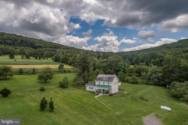 drone / aerial view featuring a forest view and a rural view