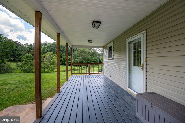 wooden deck featuring a yard